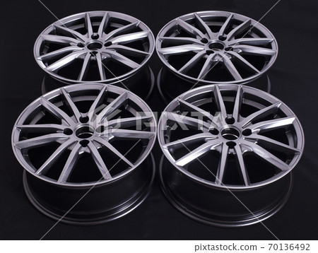 Modern automotive alloy wheel made of aluminum on a black background, industry. Designer fashion wheels for car 70136492