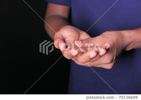 man suffering pain in hand with copy space  70136689