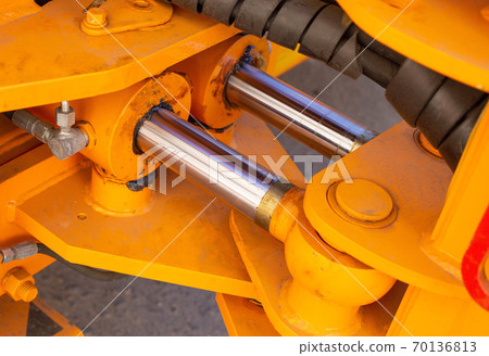 Powerful hydraulic pumps that stand in the bucket of an excavator, industry, close-up, orange Powerful hydraulic pumps that stand in the bucket of an excavator, industry, close-up, orange 70136813