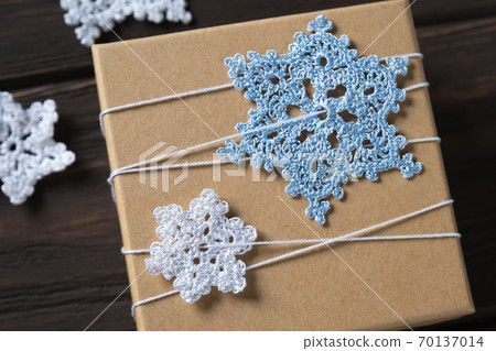 Idea gifts wrapping of the Christmas gift and decoration with knitted snowflakes. Idea gifts wrapping of the Christmas gift and decoration with knitted snowflakes. 70137014