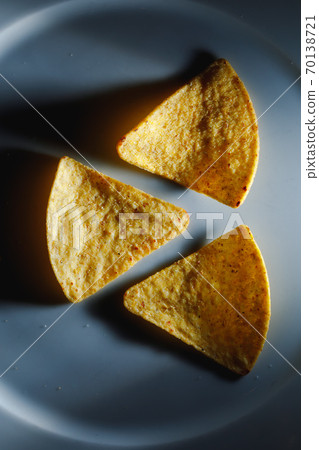 mexican nachos tortilla chips on plate, close-up view 70138721
