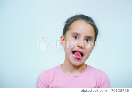 portrait of a girl who makes grimaces. portrait of a girl who makes grimaces. 70138796