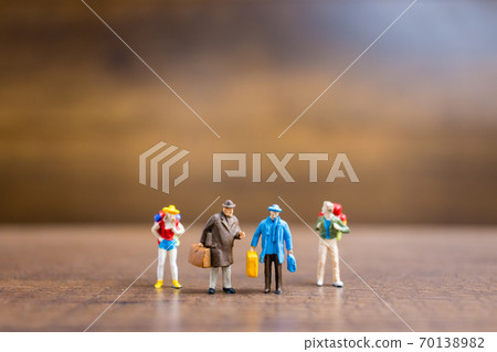 Miniature people travelers standing on wooden background , Travel concept Miniature people travelers standing on wooden background , Travel concept 70138982