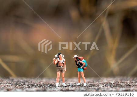 Miniature Backpacker standing on the concrete wall with natural background Miniature Backpacker standing on the concrete wall with natural background 70139110