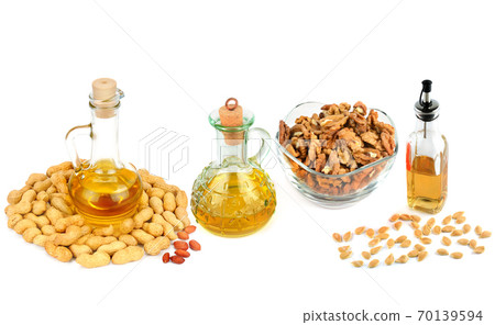 Set of vegetable oils, nuts and seeds isolated on white background. Panoramic collage. Set of vegetable oils, nuts and seeds isolated on white background. Panoramic collage. 70139594