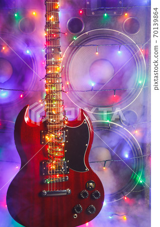 abstract guitar with festive Christmas lights and music speakers in smoke abstract guitar with festive Christmas lights and music speakers in smoke 70139864