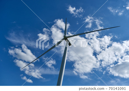 Wind turbine on blue sky background, ecological power. Alternative energy source. Wind turbine on blue sky background, ecological power. Alternative energy source. 70141091