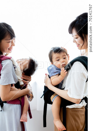 Mom friends holding an infant Mom friends holding an infant 70141767