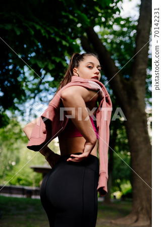 Young woman is resting after jogging in the park. 70142231