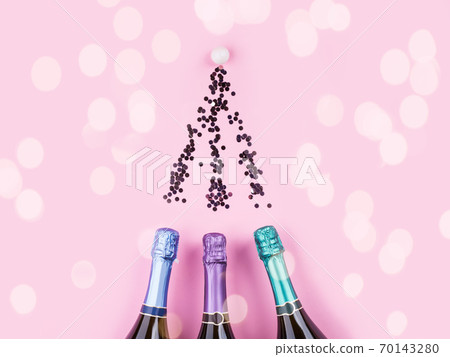 Three colorful bottles of champagne on pink Three colorful bottles of champagne on pink 70143280