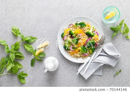 Vegan quinoa and broccoli warm salad with oranges and fresh onion, top down view Vegan quinoa and broccoli warm salad with oranges and fresh onion, top down view 70144146