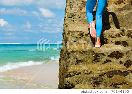 Young girl with slim body running up by stairs 70144190