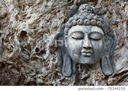 Buddha traditional face portrait carved on wood Buddha traditional face portrait carved on wood 70144218