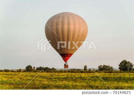 Hot air balloon in the sky low above the ground 70144625