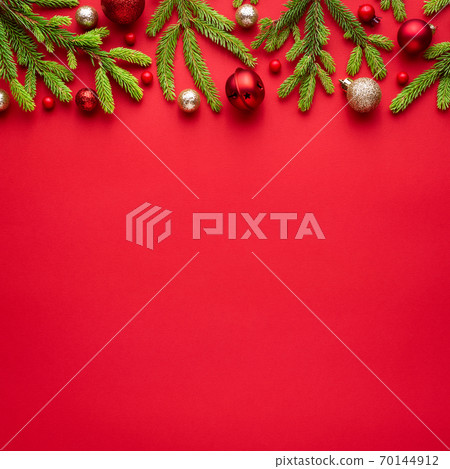 Square christmas card with fir decorations on red background Square christmas card with fir decorations on red background 70144912