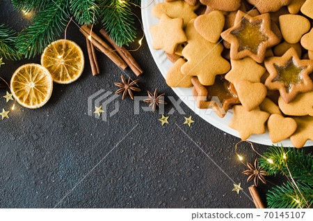 Christmas and culinary background with a plate of freshly baked Christmas gingerbread. Christmas and culinary background with a plate of freshly baked Christmas gingerbread. 70145107