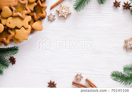 Christmas and culinary background with a plate of freshly baked Christmas gingerbread Christmas and culinary background with a plate of freshly baked Christmas gingerbread 70145108