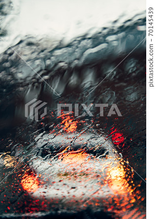 Blurred city street during dark rainy day 70145439