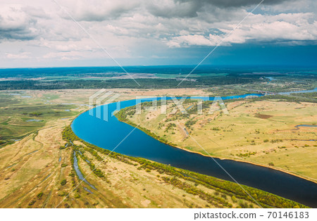 Rechytsa, Gomel Region, Belarus. Aerial View Of Dnieper River. Sky Above Green Meadow And River Landscape. Top View Of European Nature From High Attitude In Summer. Bird's Eye View Rechytsa, Gomel Region, Belarus. Aerial View Of Dnieper River. Sky Above Green Meadow And River Landscape. Top View Of European Nature From High Attitude In Summer. Bird's Eye View 70146183
