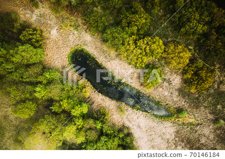 Belarus. Aerial View Of Dry Grass And Small Bog Marsh Swamp Wetland Landscape In Spring Day. High Attitude View. Marsh Bog. Bird's Eye View Belarus. Aerial View Of Dry Grass And Small Bog Marsh Swamp Wetland Landscape In Spring Day. High Attitude View. Marsh Bog. Bird's Eye View 70146184