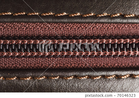 zipper of brown leather bag, close-up view 70146323