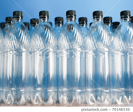 empty plastic bottles on blue background empty plastic bottles on blue background 70146530