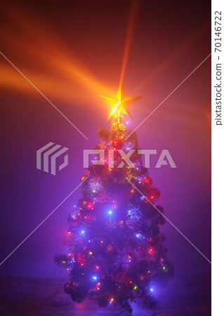 Christmas tree with festive lights, purple background with mist 70146722