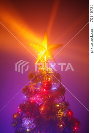 Christmas tree with festive lights, purple background with mist Christmas tree with festive lights, purple background with mist 70146723