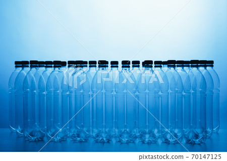 empty plastic bottle silhouettes on blue background empty plastic bottle silhouettes on blue background 70147125