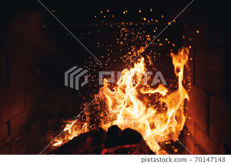 burning fire logs with sparks in the fireplace 70147148