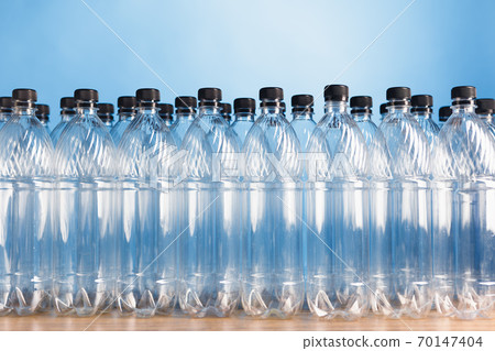 empty plastic bottles on blue background empty plastic bottles on blue background 70147404
