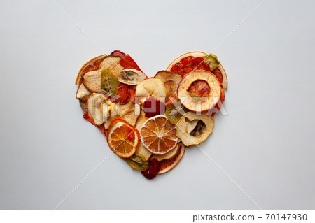 Colorful dried fruit slices heart isolated on white background Colorful dried fruit slices heart isolated on white background 70147930