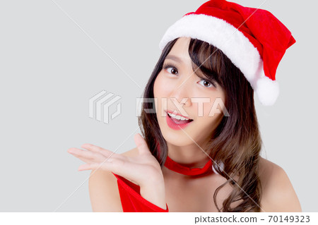 Beautiful portrait young asian woman Santa costume presenting empty plam with happy in holiday. Beautiful portrait young asian woman Santa costume presenting empty plam with happy in holiday. 70149323