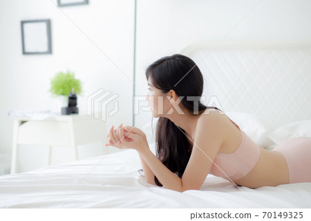 Beautiful portrait young asian woman sexy in underwear figure fit relax with seductive in bedroom. Beautiful portrait young asian woman sexy in underwear figure fit relax with seductive in bedroom. 70149325
