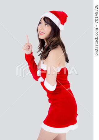 Beautiful portrait young asian woman Santa costume smiling present pointing something in xmas. Beautiful portrait young asian woman Santa costume smiling present pointing something in xmas. 70149326