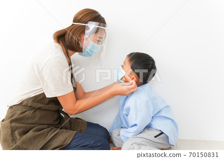 Nursery teacher wearing a mask for kindergarten children 70150831