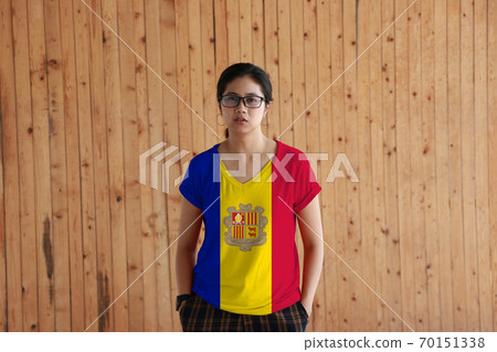 Woman wearing Andorra flag color shirt and standing with two hands in pant pockets Woman wearing Andorra flag color shirt and standing with two hands in pant pockets 70151338