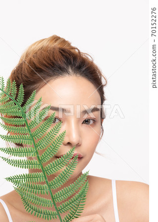 Beautiful Asian young woman touching soft cheek smile with clean fresh skin Happiness and cheerful Beautiful Asian young woman touching soft cheek smile with clean fresh skin Happiness and cheerful 70152276