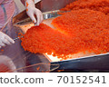 Preparing salmon caviar in the fishing processing plant 70152541