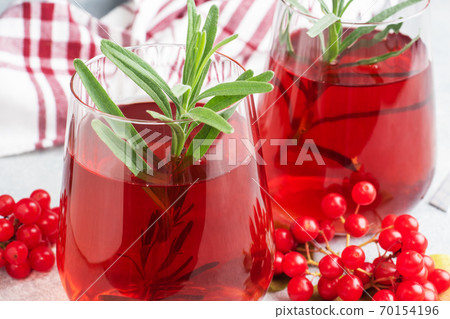 Drink from the berries of red viburnum in glass Cup. Berry compote with vitamin C against the common cold. Drink from the berries of red viburnum in glass Cup. Berry compote with vitamin C against the common cold. 70154196