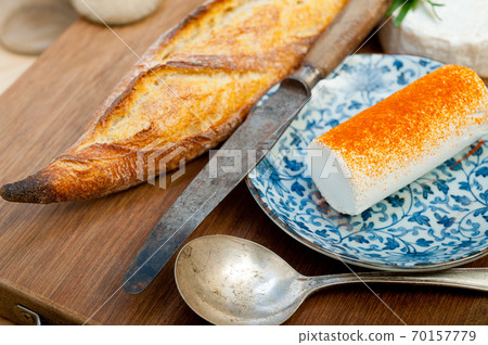 French cheese and fresh baguette on a wood cutter French cheese and fresh baguette on a wood cutter 70157779