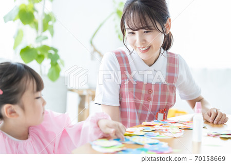 Childcare image: A girl and a childcare worker who work Childcare image: A girl and a childcare worker who work 70158669