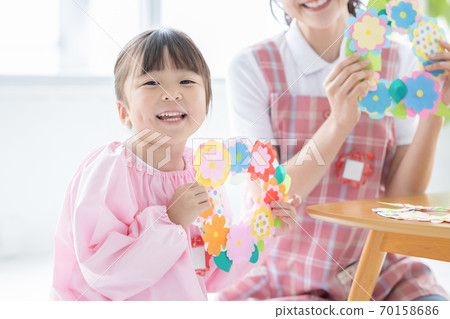 Childcare image: A girl and a childcare worker who work Childcare image: A girl and a childcare worker who work 70158686