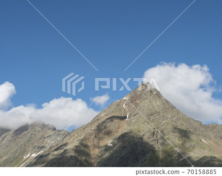 view from Nurnberger Hutte mountain hut at valley with sharp mountain peaks at Stubai hiking trail, Stubai Hohenweg, Summer rocky alpine landscape of Tyrol, Stubai Alps, Austria 70158885