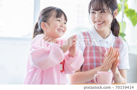 Childcare image Portrait of a nursery teacher and a girl 70159414
