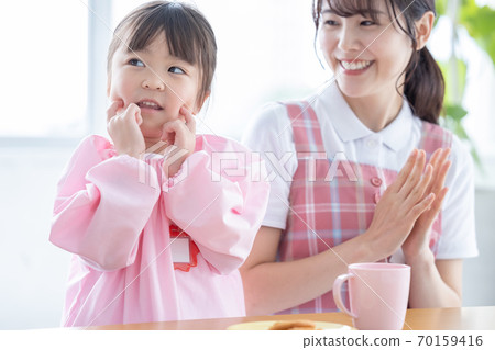 Childcare image Portrait of a nursery teacher and a girl 70159416