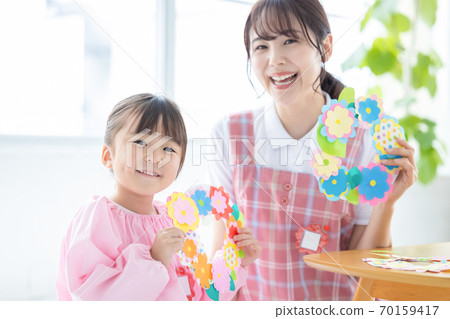 Childcare image: A girl and a childcare worker who work 70159417