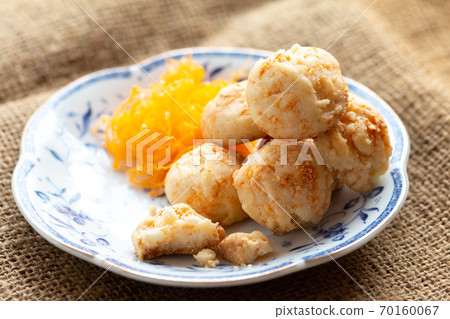 Golden cookies balls with eggs silk for tea time in morning in white plate Golden cookies balls with eggs silk for tea time in morning in white plate 70160067