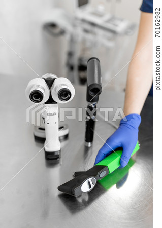 Professional equipment of a veterinary doctor ophthalmologist - manual slit lamp, ophthalmoscope, veterinary tonometer. Blurred Background 70162982