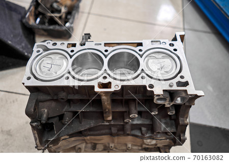 New pistons and cylinder head of engine block vehicle. Motor capital repair. Sixteen valve and four cylinder. Car service concept. The job of a mechanic. Old and new pistons. New pistons and cylinder head of engine block vehicle. Motor capital repair. Sixteen valve and four cylinder. Car service concept. The job of a mechanic. Old and new pistons. 70163082